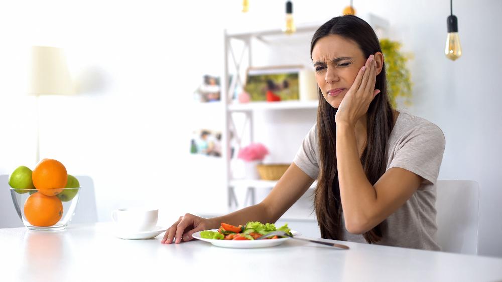 woman holding jaw in pain | tooth extraction sunnyvale ca
