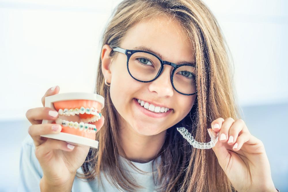 woman holding clear plastic aligner | invisalign sunnyvale ca