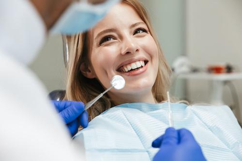 woman smiling in dental exam chair | teeth cleaning sunnyvale ca