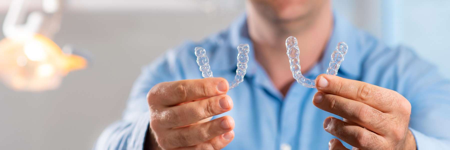 patient holding two invisalign aligners | dentist sunnyvale ca