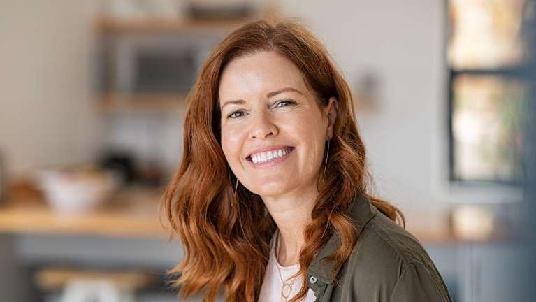 woman with red hair smiling | dental implants sunnyvale ca