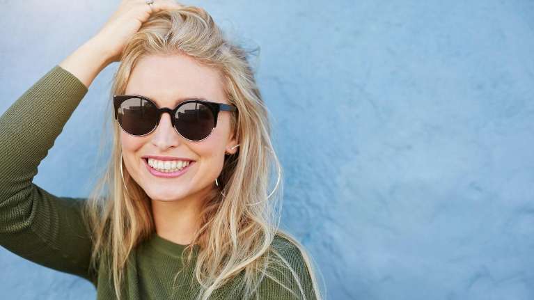woman in green shirt smiling | invisalign sunnyvale ca