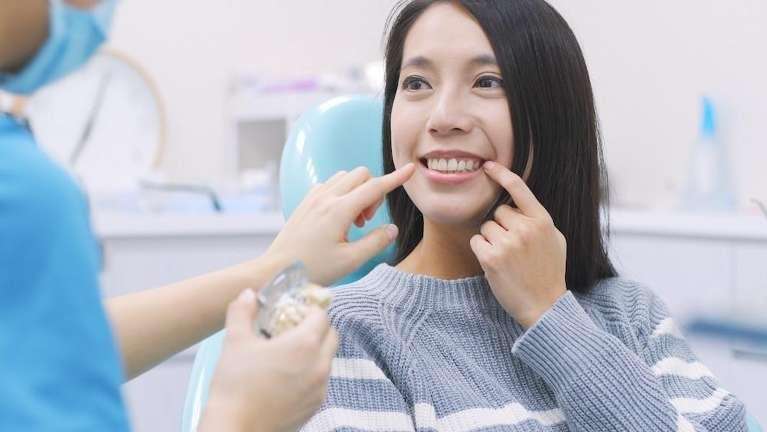 woman sitting in dentist exam chair | tooth extraction sunnyvale