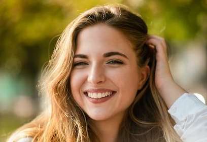 woman in white shirt smiling | dentist in sunnyvale ca