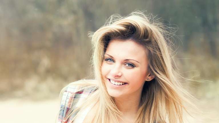 woman with blonde hair smiling | teeth cleaning sunnyvale ca