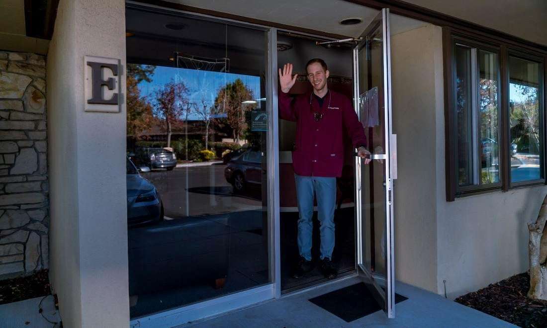 dr neri waving at front entrance | general dentistry sunnyvale ca